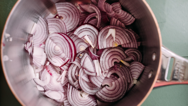 Red onions cooking in a pot