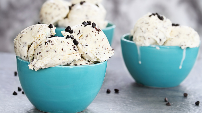 three blue bowls filled with chocolate chip ice cream