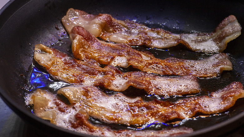 Bacon frying in a pan