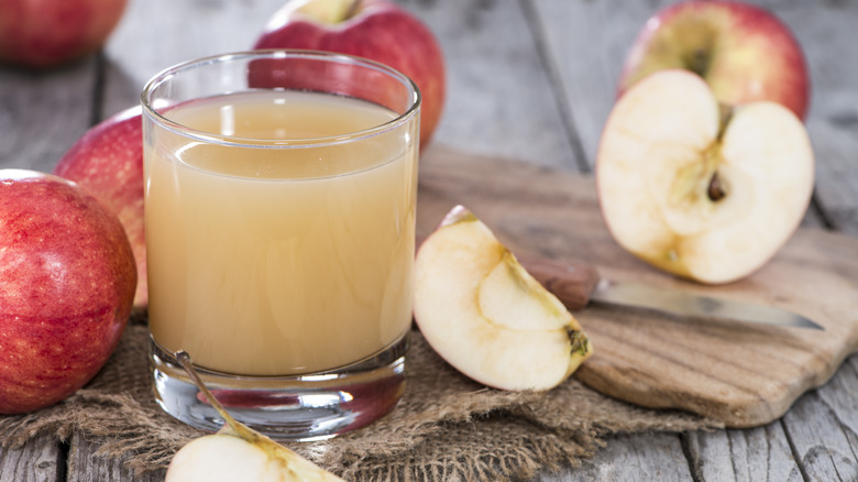 Glass of apple juice and apples