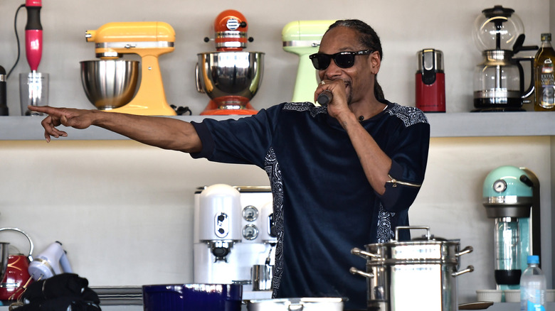 Snoop Dogg cooking in front of an audience