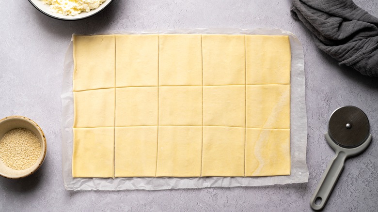 Scored sheet of puff pastry on counter