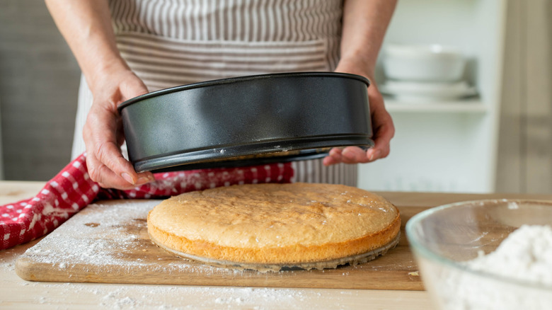 A man removing a cake from a cake pan