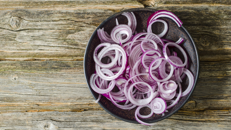 Bowl of sliced red onions