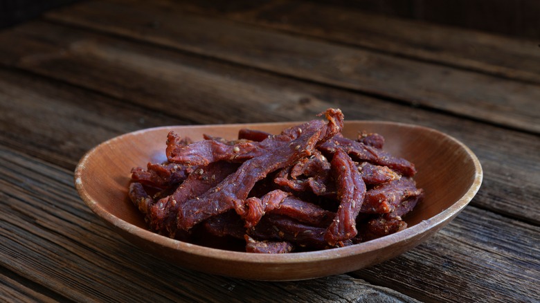 Plate of beef jerky on picnic table