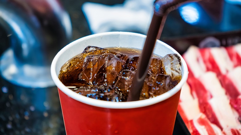 Fast food soda with ice and straw close-up