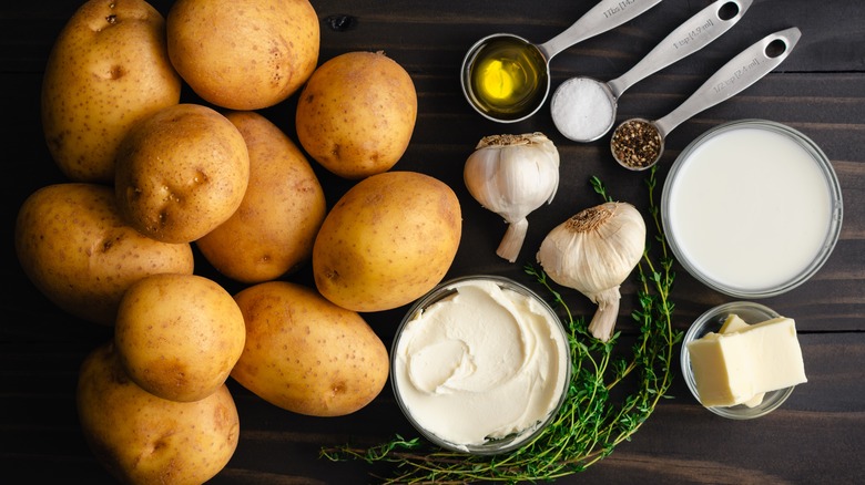 Top view of potatoes and ingredients needed to make mashed potatoes