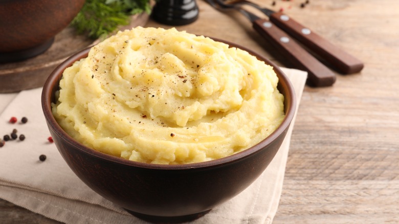 A bowl of creamy mashed potatoes on a table