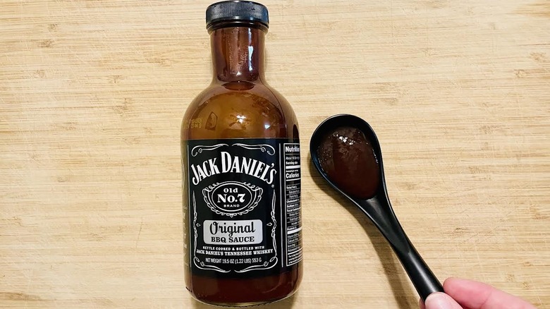 Bottle and spoonful of Jack Daniels Original BBQ Sauce