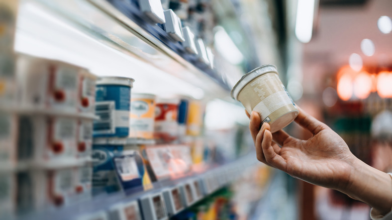 shopper choosing yogurt at the supermarket