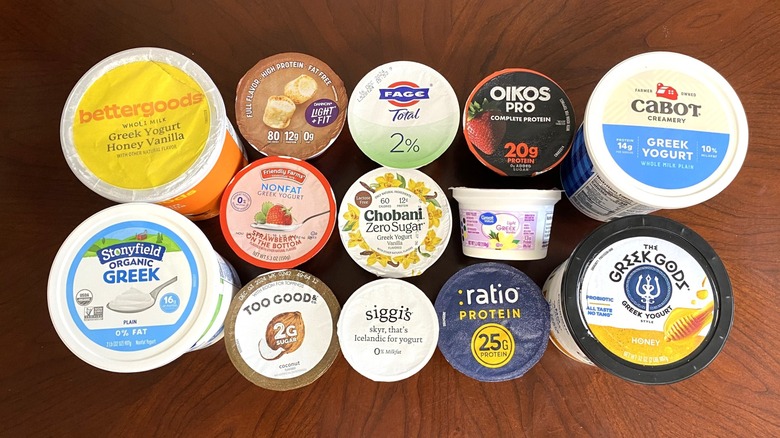 yogurt containers are sitting on a wooden surface