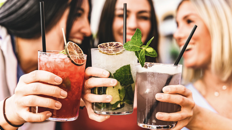 Women holding cocktails