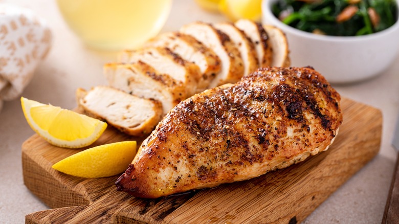 Chicken breast on wooden board