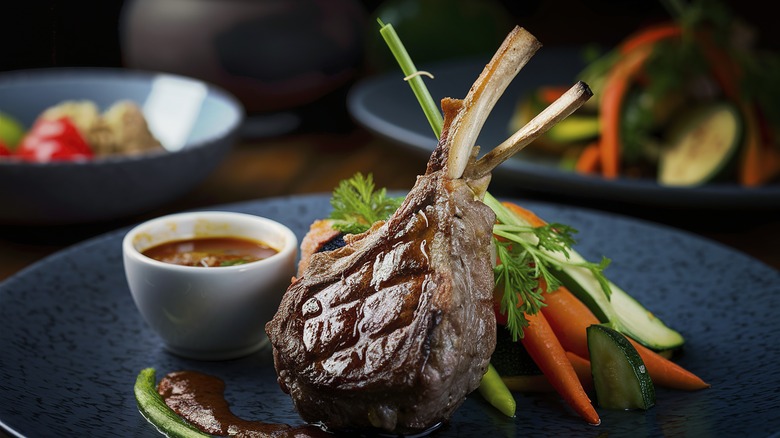 Lamb chops on black plate