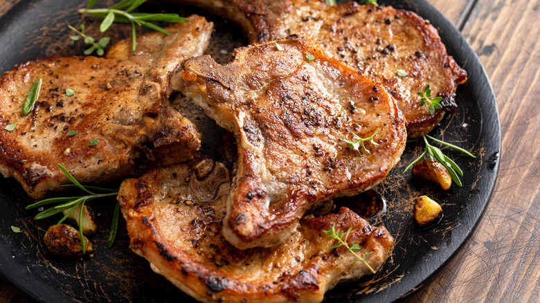 Pork chops on black plate