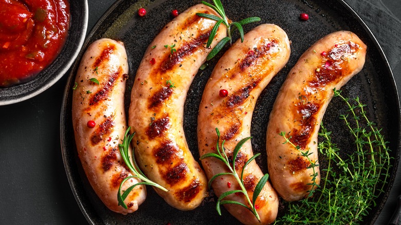 Grilled sausages on black plate