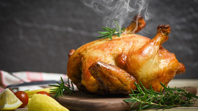 Roast chicken on wooden board