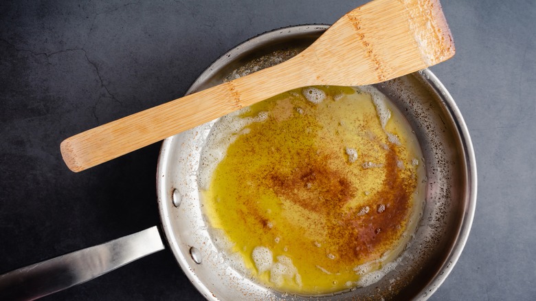 Brown butter in skillet with spatula