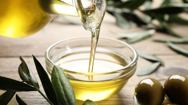 Pouring olive oil into a bowl