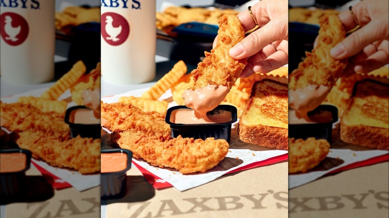 Zaxby's fried chicken tenders dipped in Zax sauce