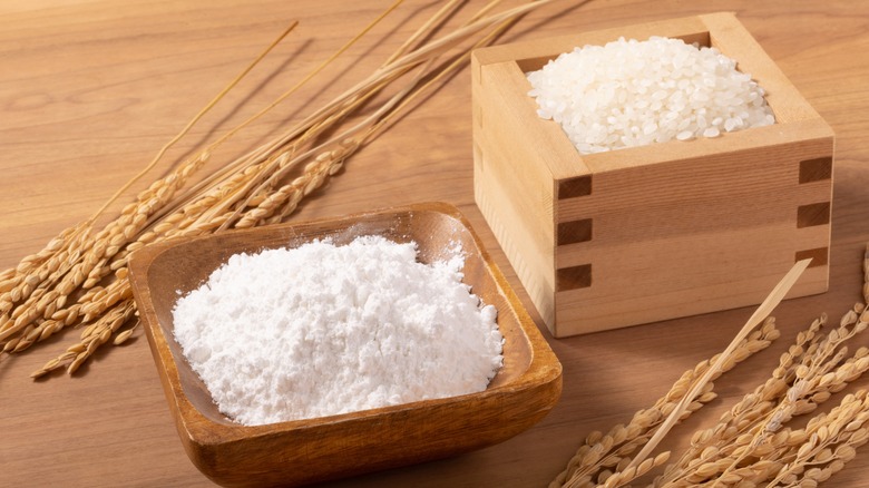 Rice flour in a bamboo dish with a box of dried rice