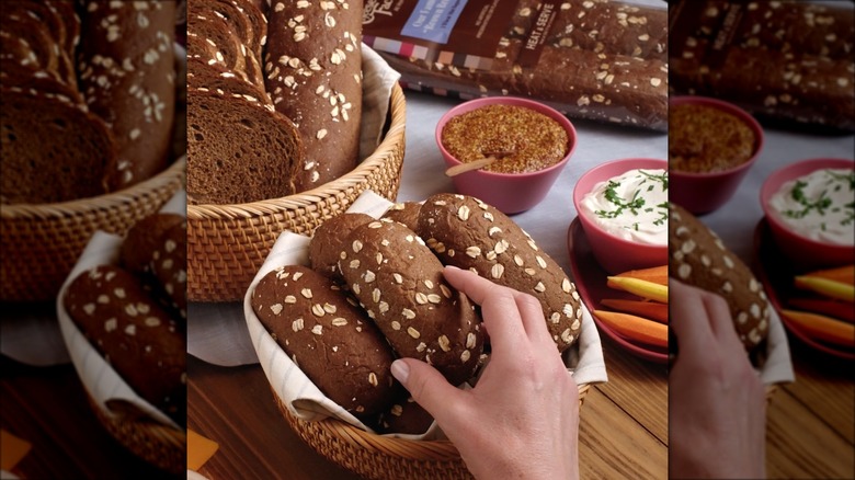 hand grabbing brown bread