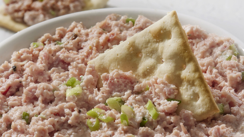 ham salad in a bowl with a cracker