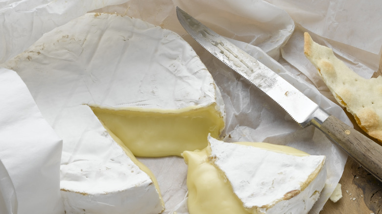 brie wheel with a wedge cut out of it
