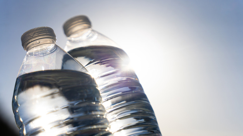 two waterbottles in front of the sun