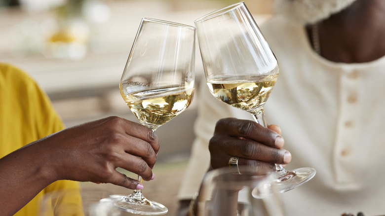 Couple holding a glasses of white wine