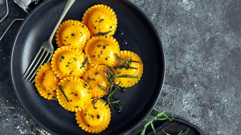 Pumpkin ravioli on black plate