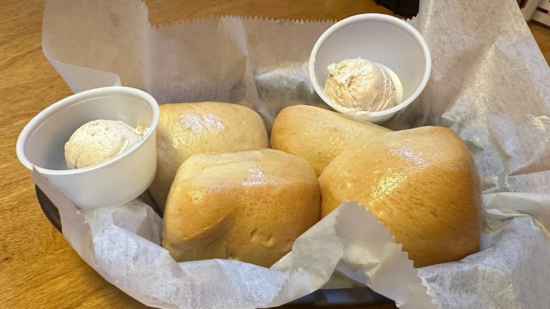 Basket of bread rolls with honey cinnamon butter from Texas Roadhouse