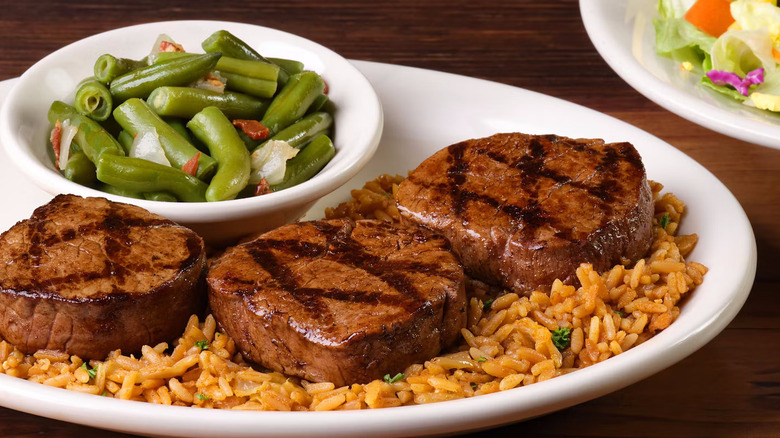 A plate of filet medallions, rice, and green beans from Texas Roadhouse