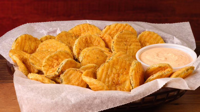 A basket of deep-fried pickles with sauce from Texas Roadhouse