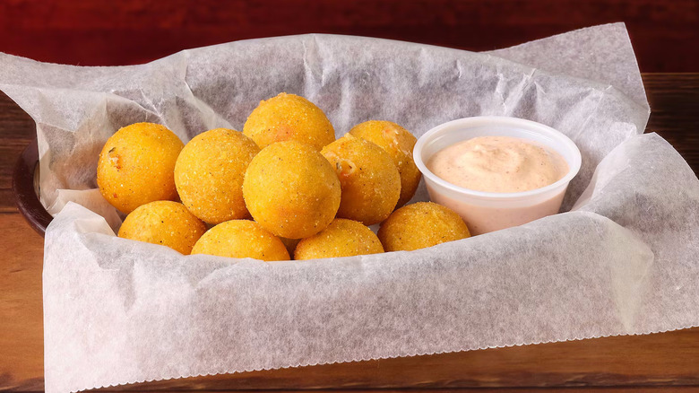 A basket of Rattlesnake Bites with dipping sauce from Texas Roadhouse