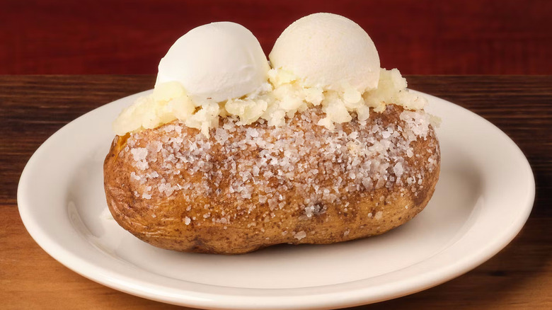 A baked potato with salt and butter from Texas Roadhouse