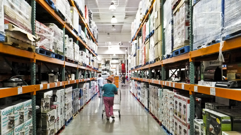 Customer walking through Costco aisle