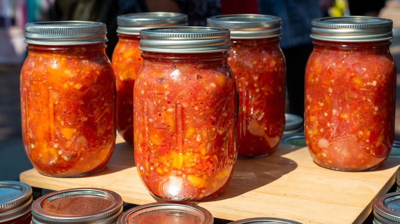 Glass canning jars full of red salsa