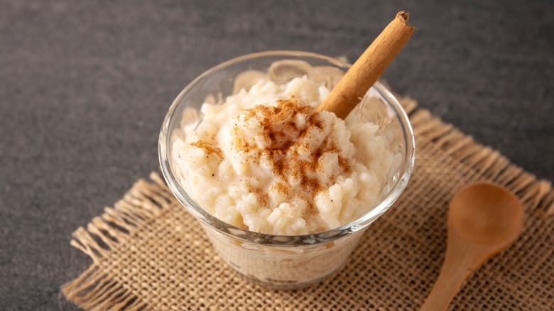 cup of rice pudding with a cinnamon stick