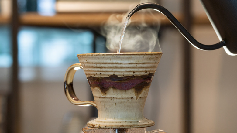 Pouring water into coffee grounds