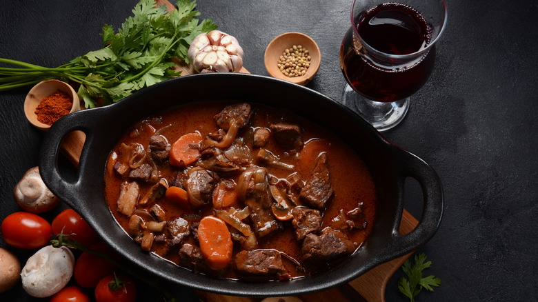 A pot of beef bourguignon on a table