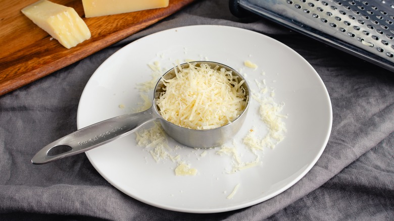 Grated parmesan in measuring cup