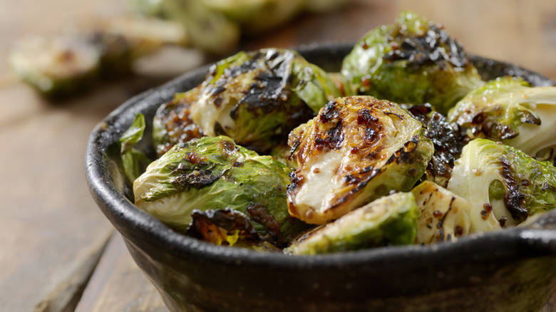 A bowl of roasted Brussels sprouts in close-up.