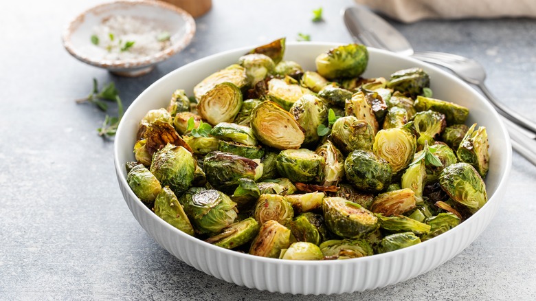 White bowl filled with roasted Brussels sprouts.