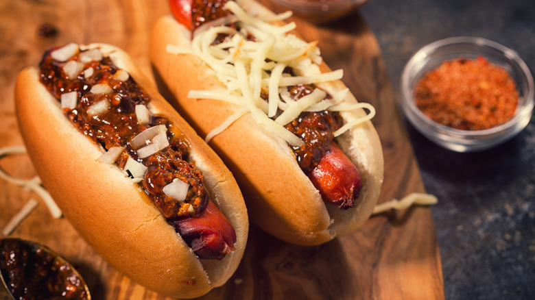 Chili dogs on wooden board