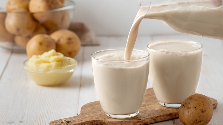 Glass of milk alongside potatoes