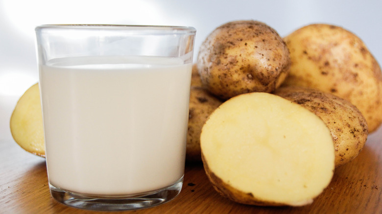 Glass of milk alongside potatoes