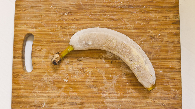 frozen banana on cutting board