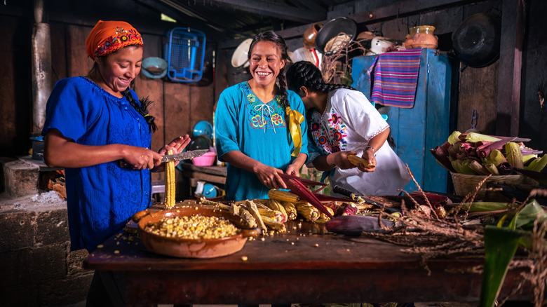 Several young women making tamales together