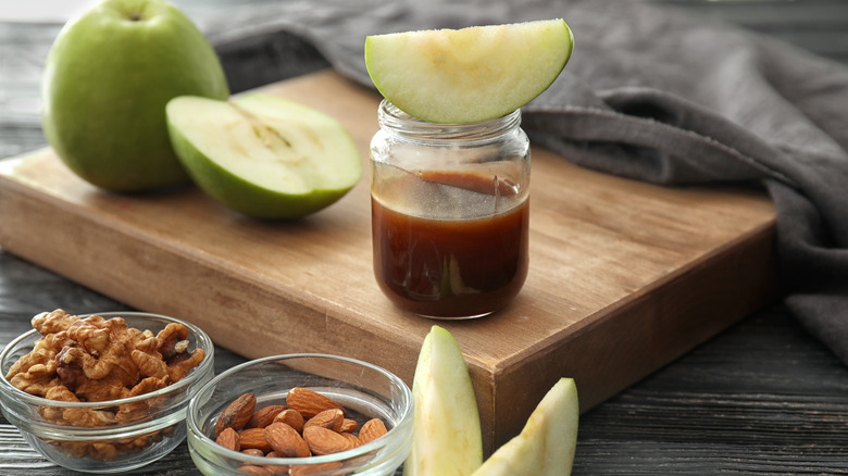 Apples sliced and whole with nuts, caramel